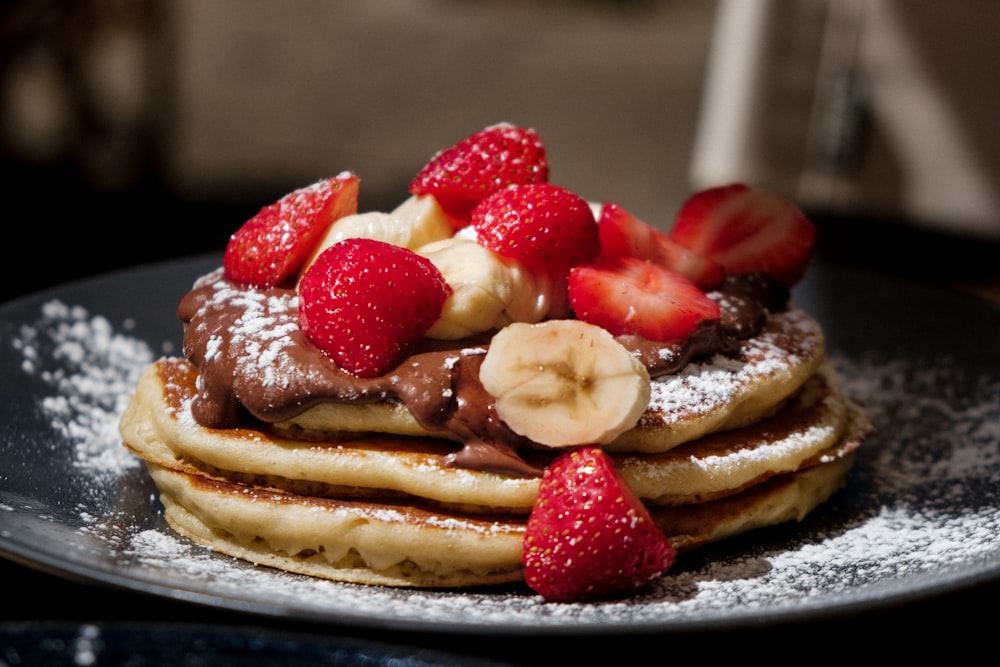 pancakes with strawberries and blueberries on top