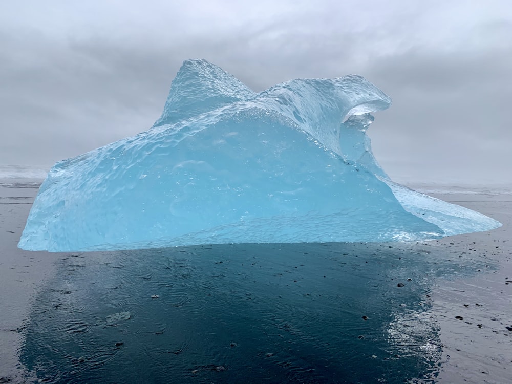 white ice formation on blue ocean water during daytime