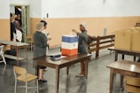 A ballot box surrounded by engaged voters.