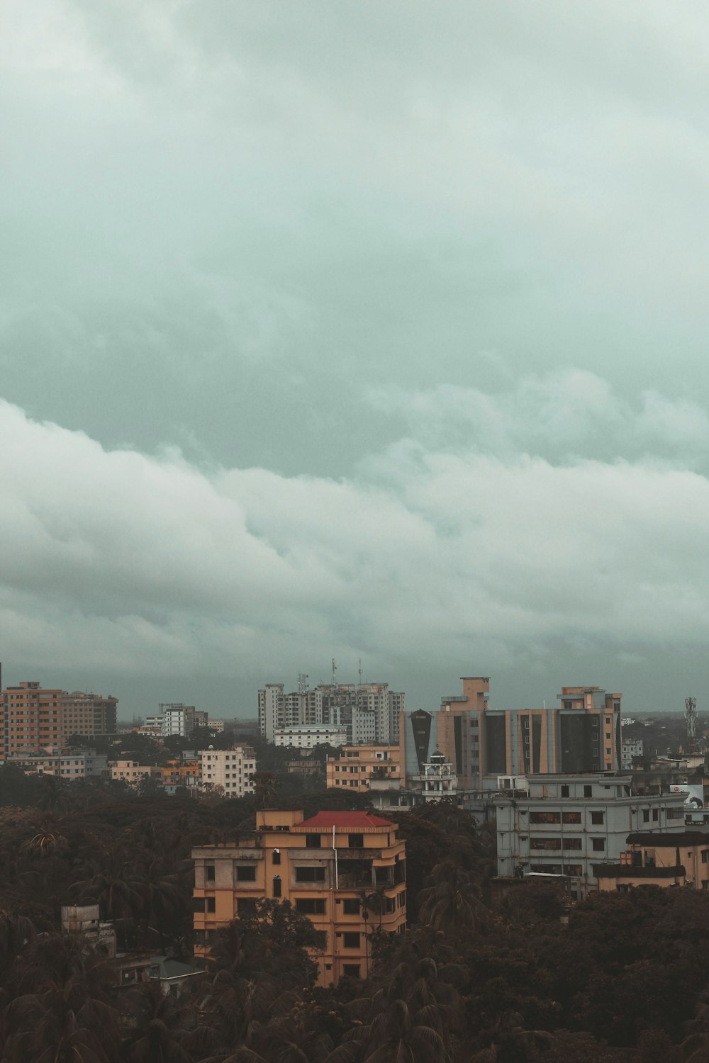 city buildings under white clouds during daytime