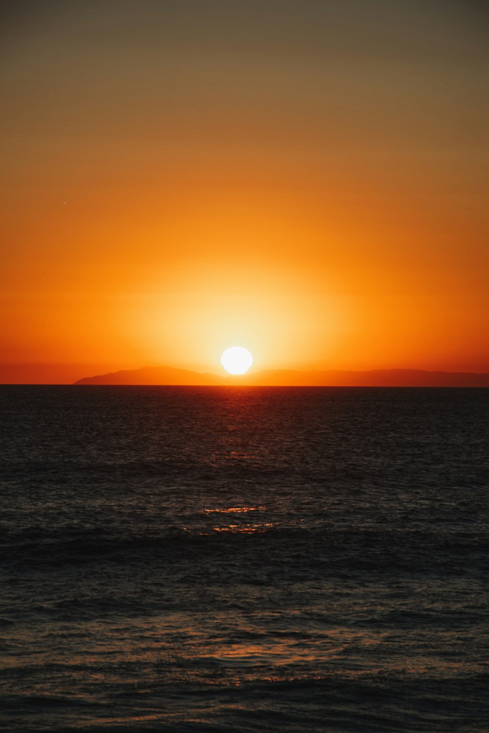 body of water during sunset