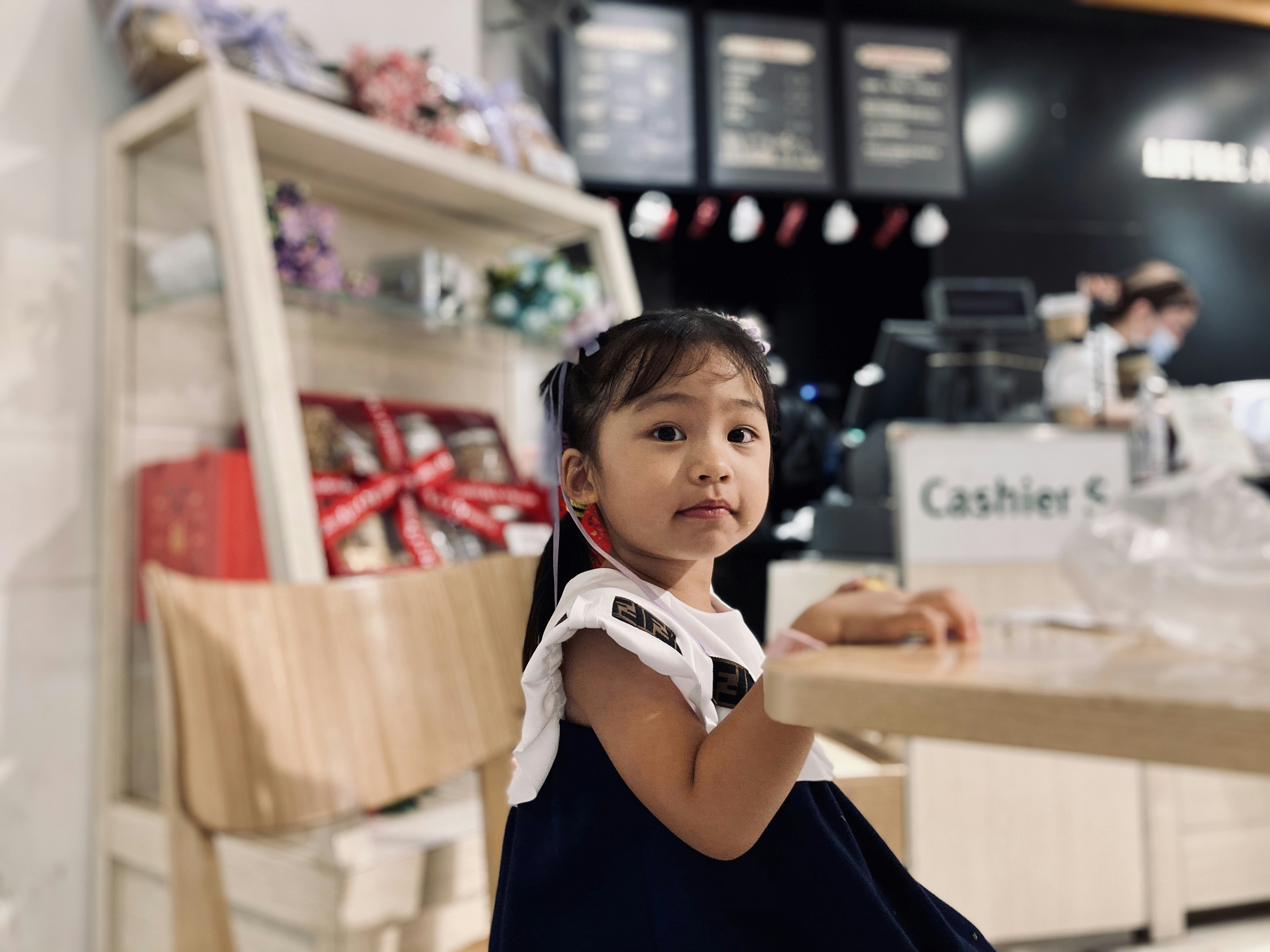 woman in black and white long sleeve shirt sitting on brown wooden chair