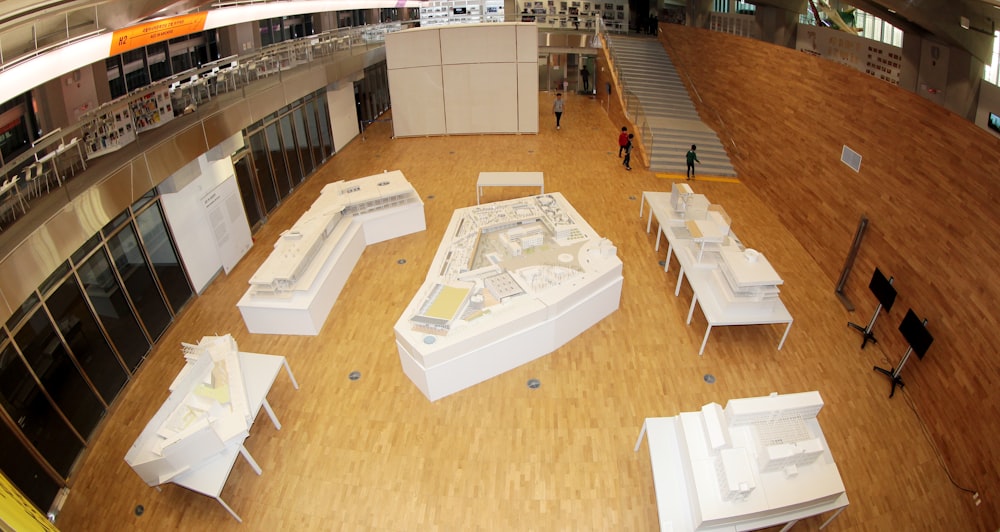 white wooden table and chairs on brown wooden floor