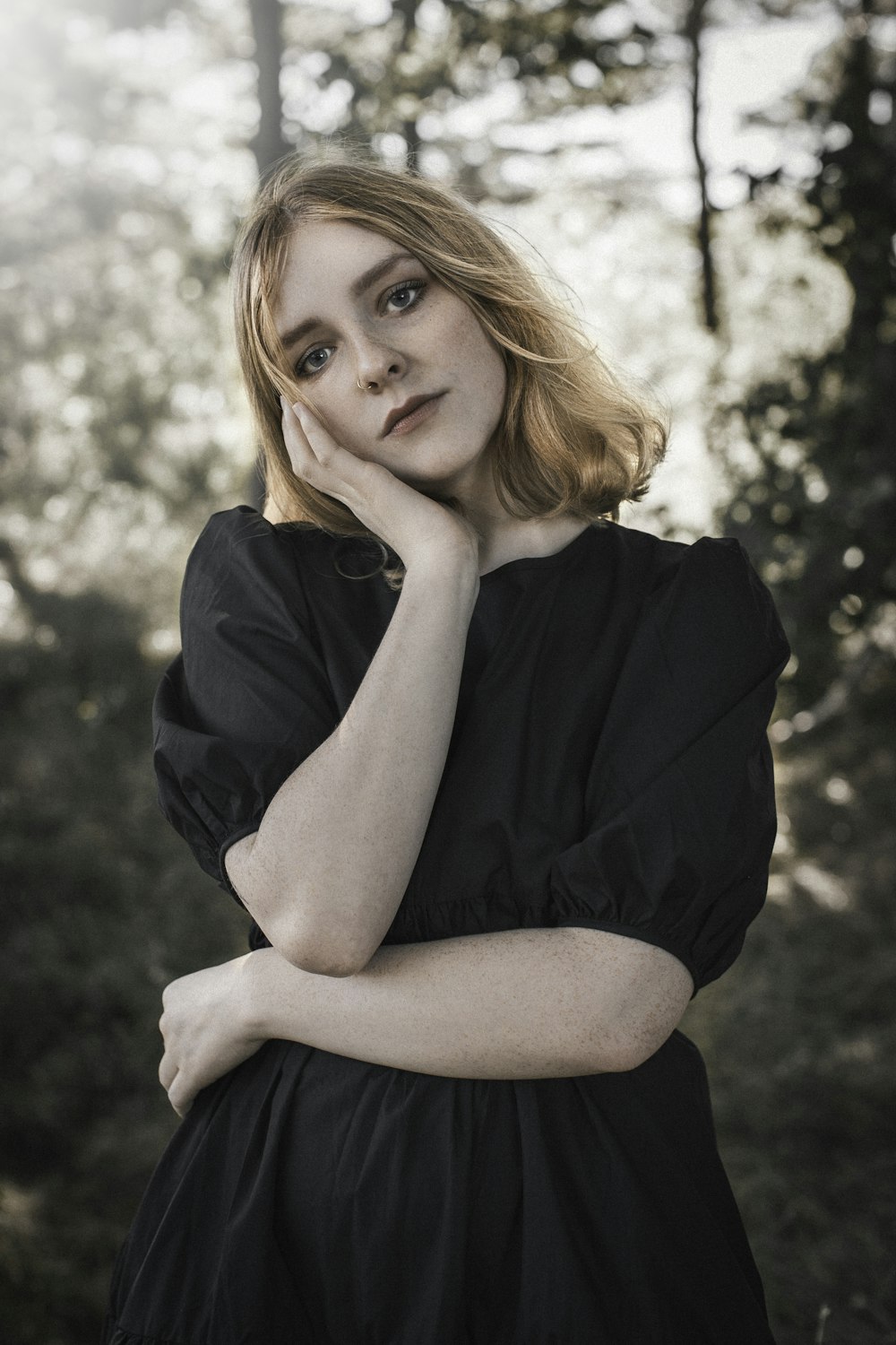 woman in black shirt sitting on ground