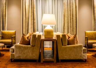 A cozy living room featuring a plush fabric sofa paired with a sleek leather two-seater sofa.