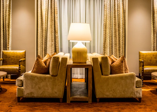 Cozy living room with warm lighting and elegant furniture arranged for comfort.