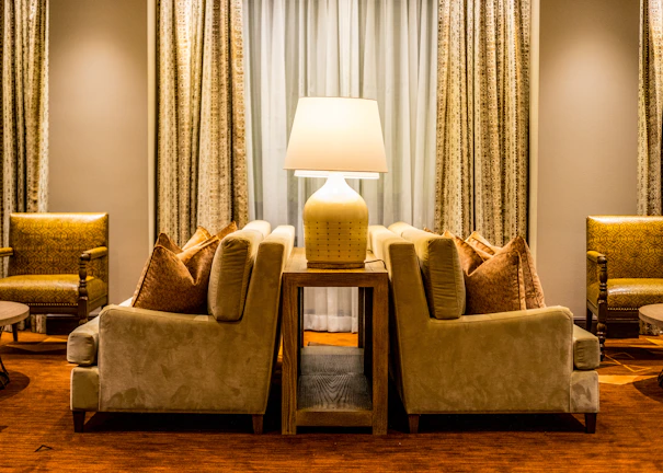 Elegant living room with plush designer sofas and warm beige accents.