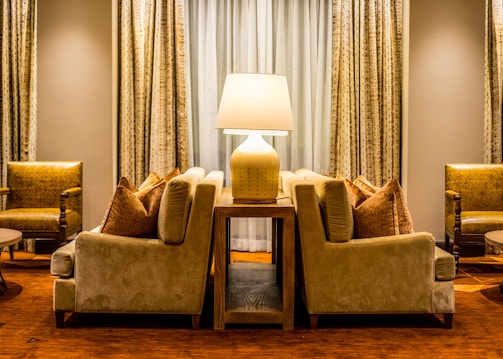 A cozy living room featuring a plush fabric sofa paired with a sleek leather two-seater sofa.