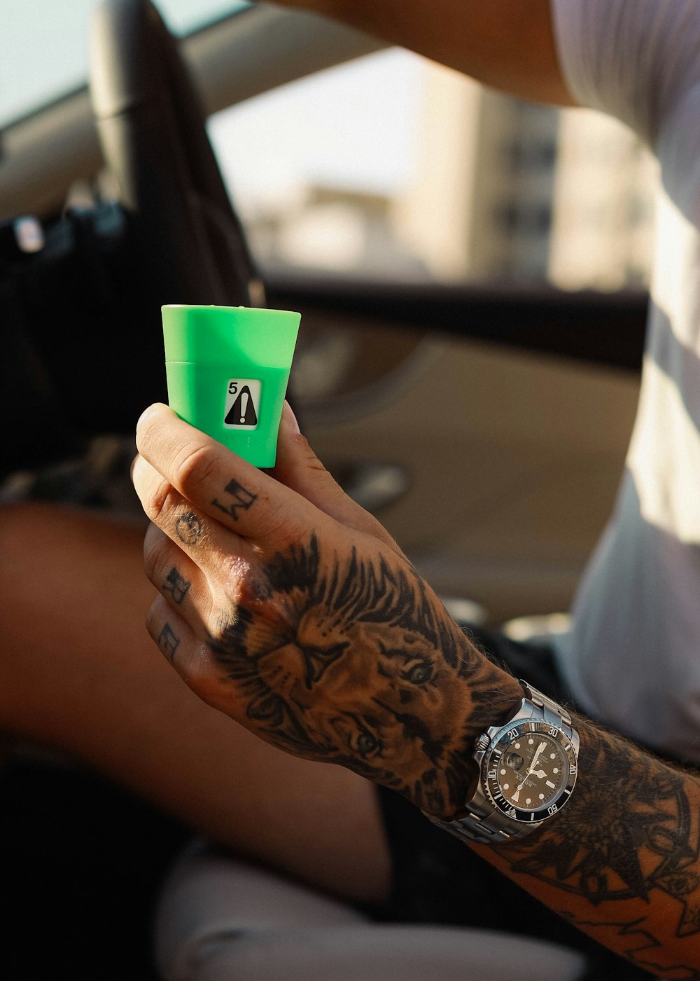 person holding green plastic cup