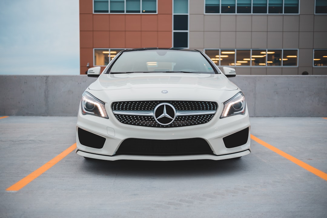 white mercedes benz car parked near building