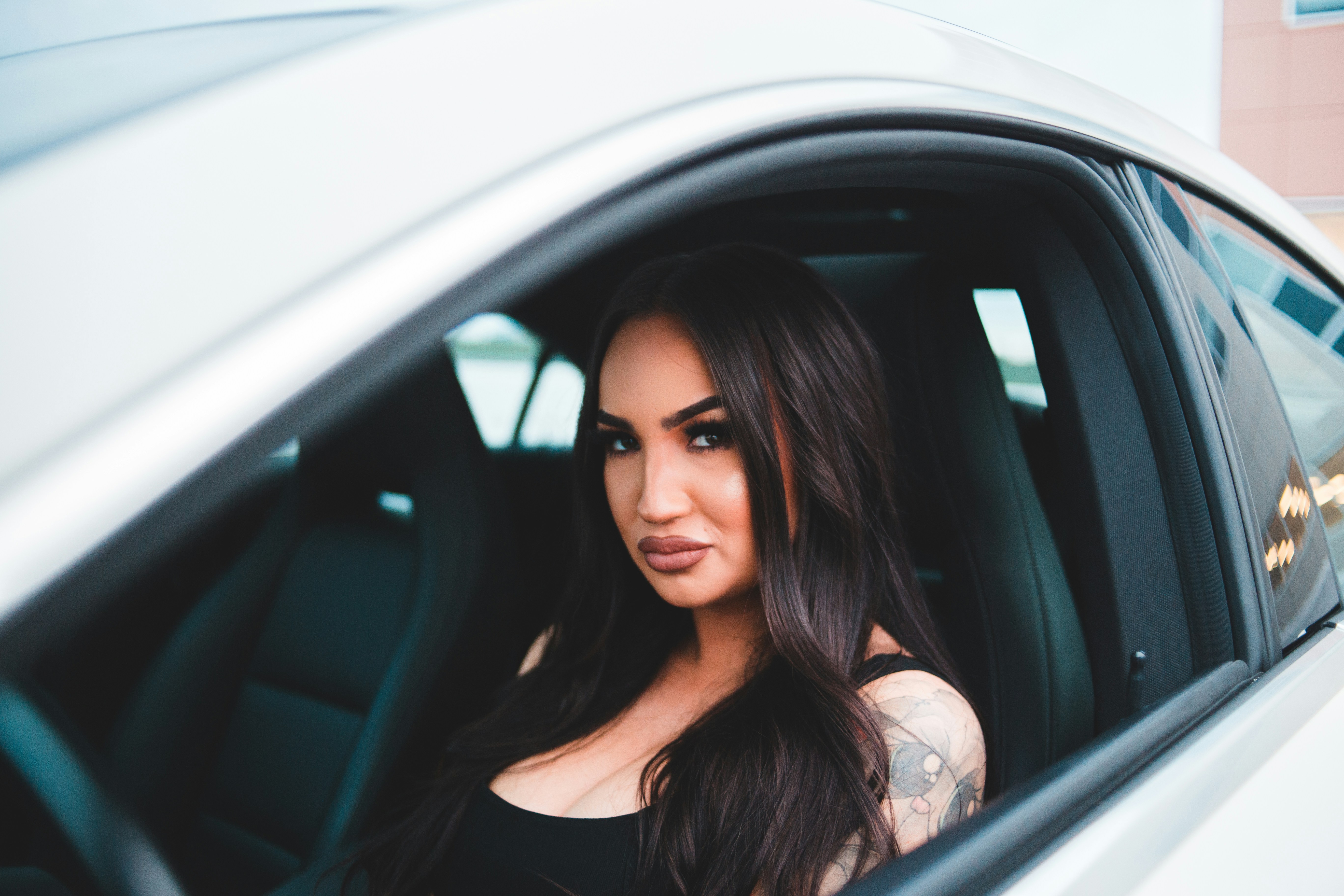 woman in black tank top sitting inside car