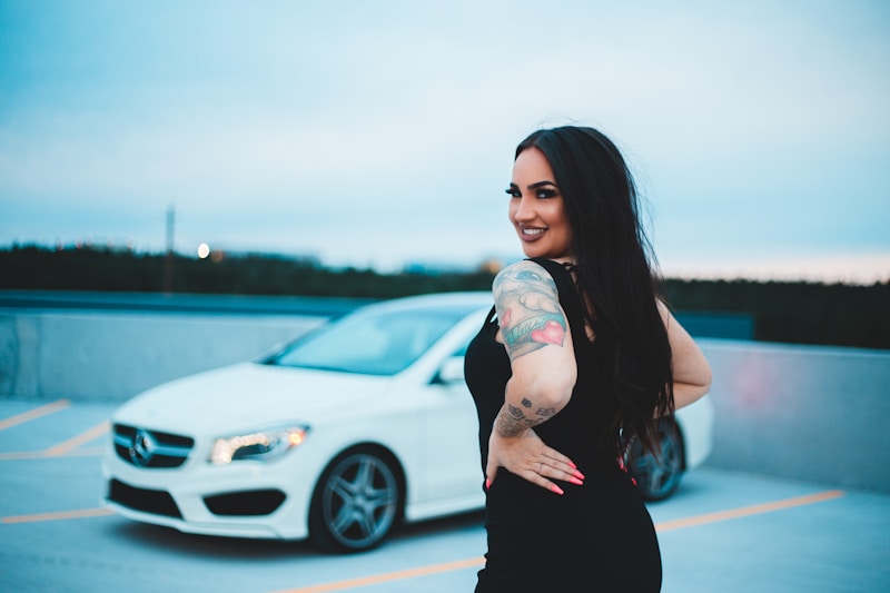 Glamorous woman by white car