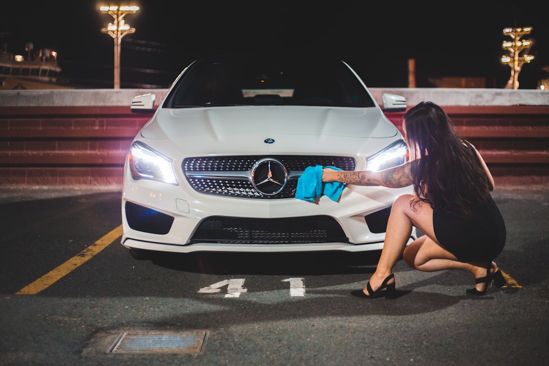 woman in white dress sitting on white mercedes benz car