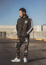 An athlete confidently showcasing branded sports apparel during an outdoor training session.