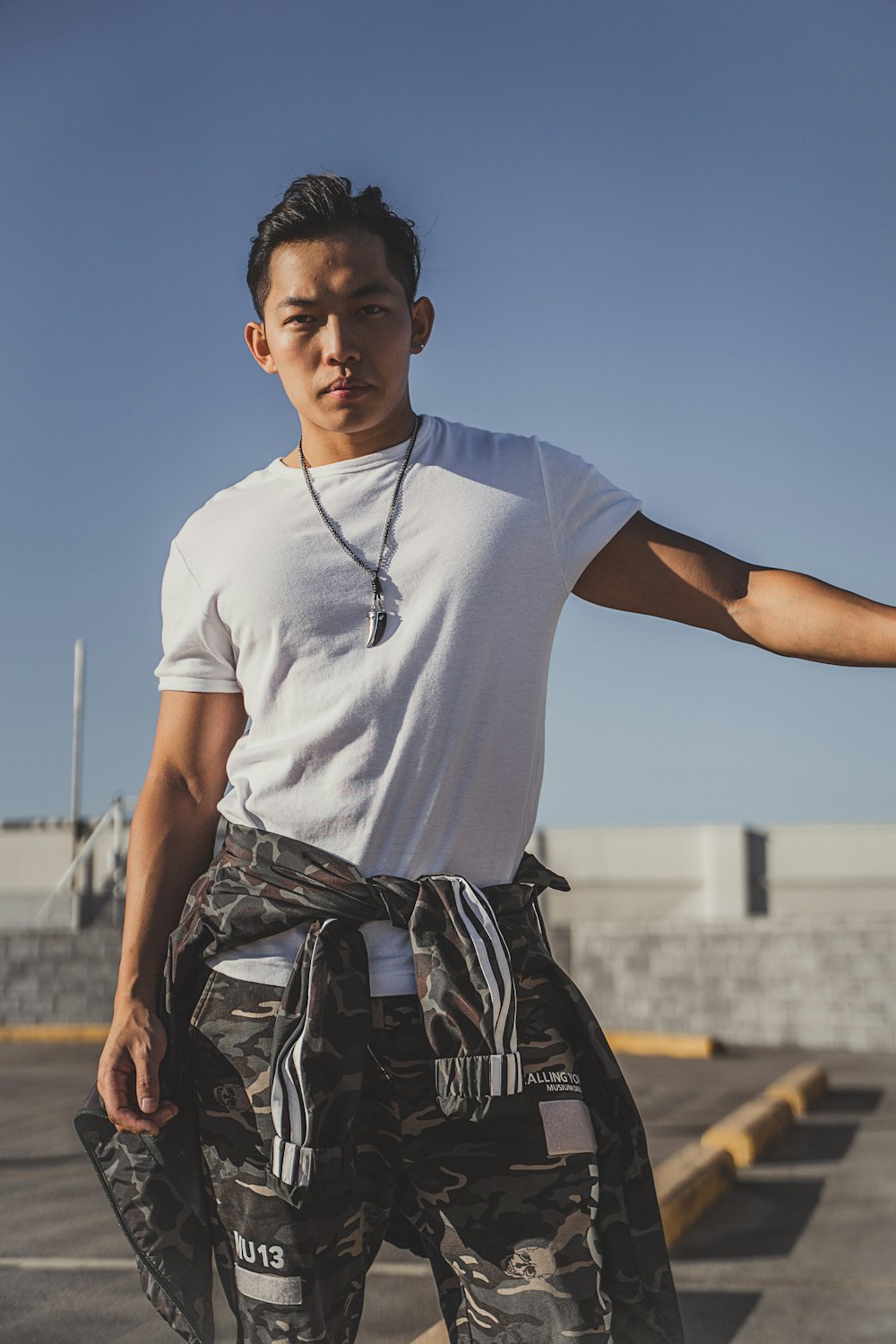 man in white crew neck t-shirt and black and gray backpack