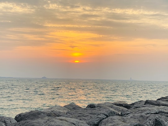 gray rocks near body of water during sunset in Al Khan United Arab Emirates