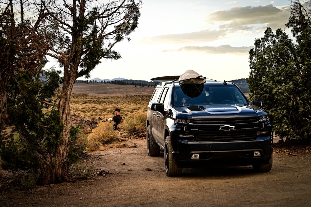 black suv on dirt road during daytime