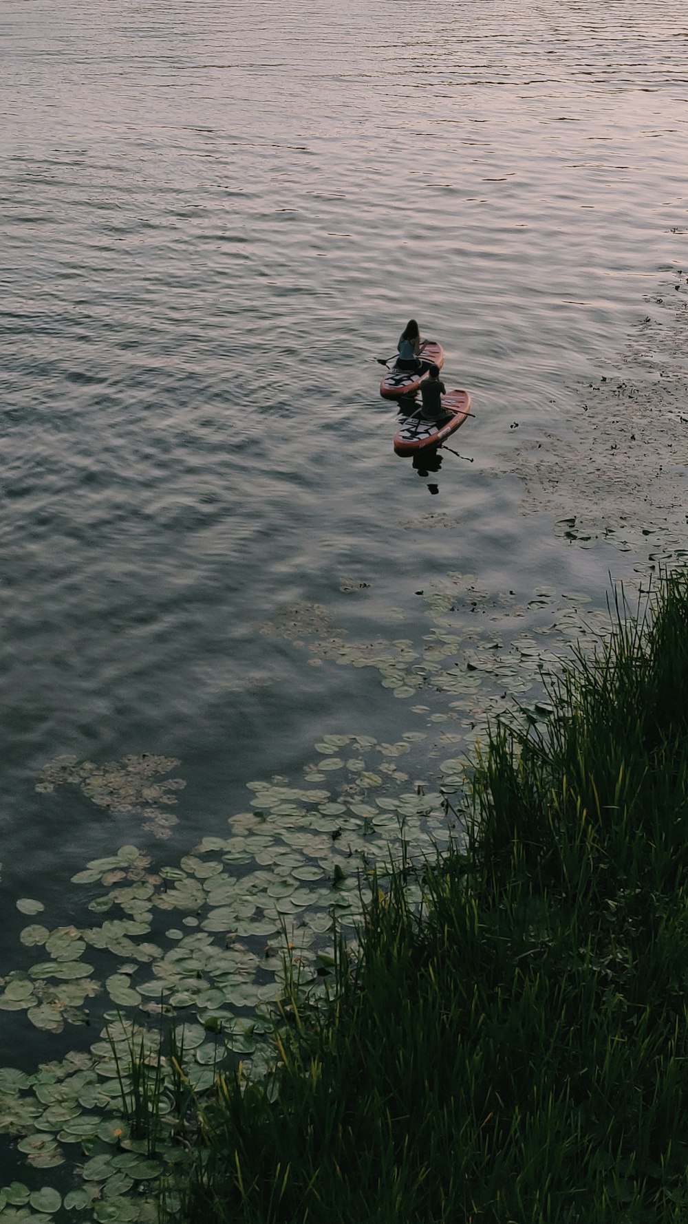 person in black and red jacket and black pants on water during daytime