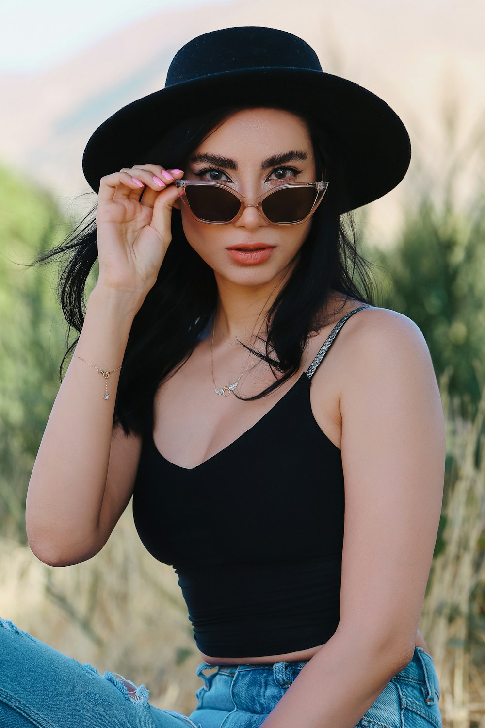 woman in black tank top wearing black sunglasses