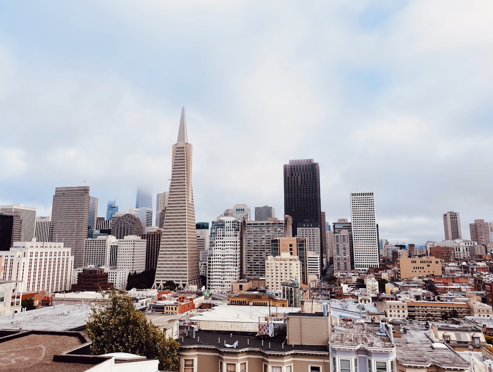 city buildings under white clouds during daytime