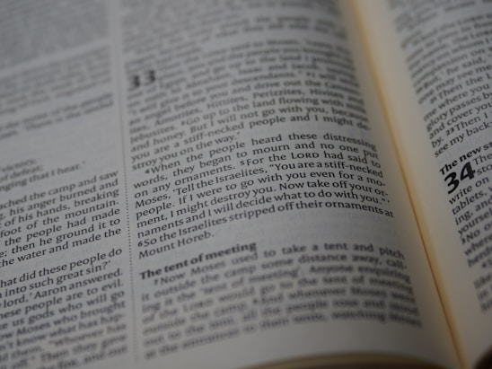 An open book with visible text, focusing on a passage that highlights a biblical story. The text is printed in columns with a header indicating a chapter number.