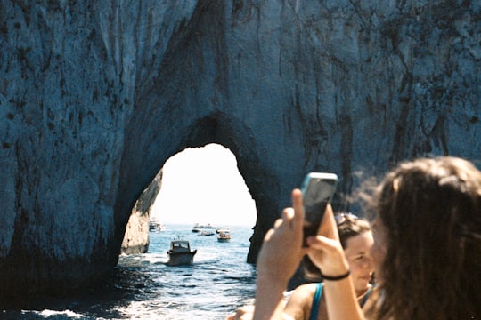 woman in blue tank top holding silver iphone 6 in Capri Italy