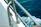 Close-up of a durable marine exhaust fan mounted on a boat deck with ocean waves in the background.