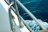 Close-up of a durable marine exhaust fan mounted on a boat deck with ocean waves in the background.