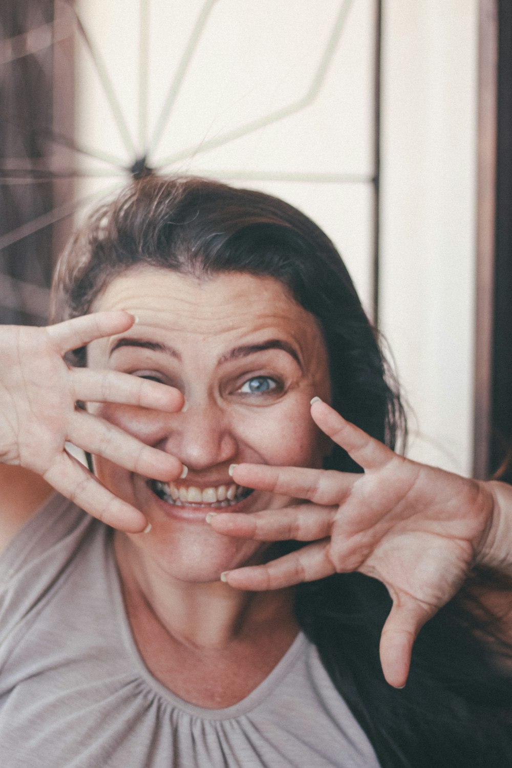 woman in white crew neck shirt covering her face