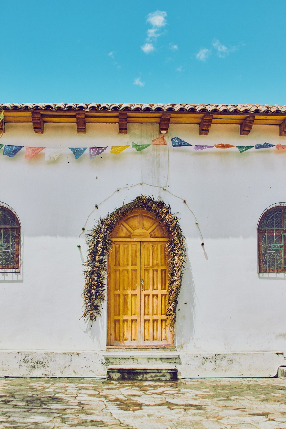 brown wooden door on white concrete house