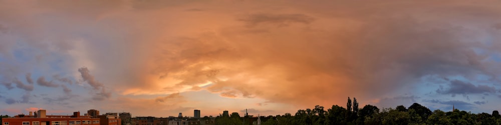 a large cloud is in the sky over a city