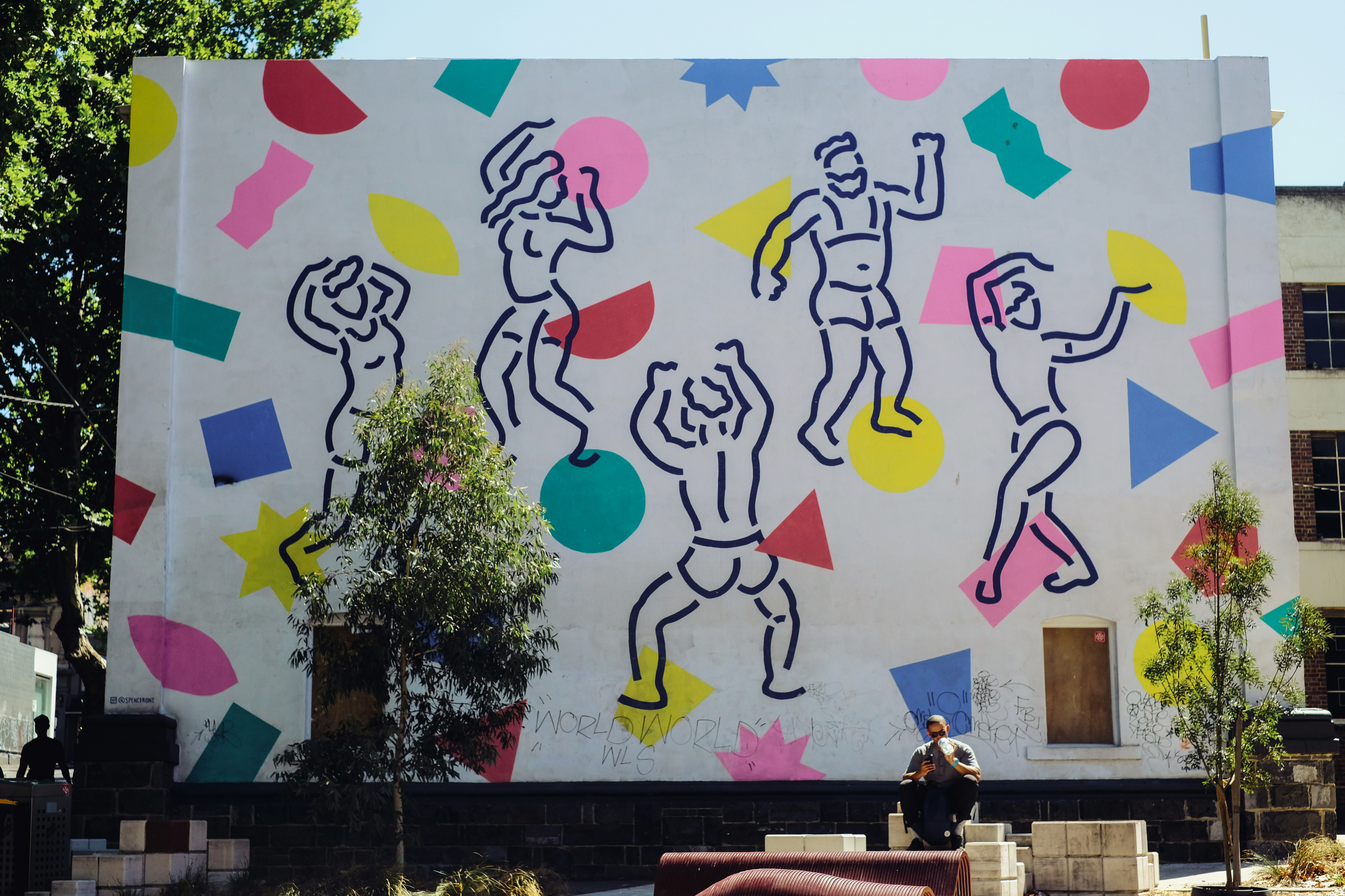 woman in white shirt sitting on brown wooden bench