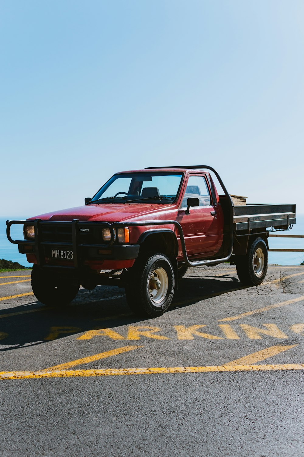 red chevrolet single cab pickup truck on road during daytime