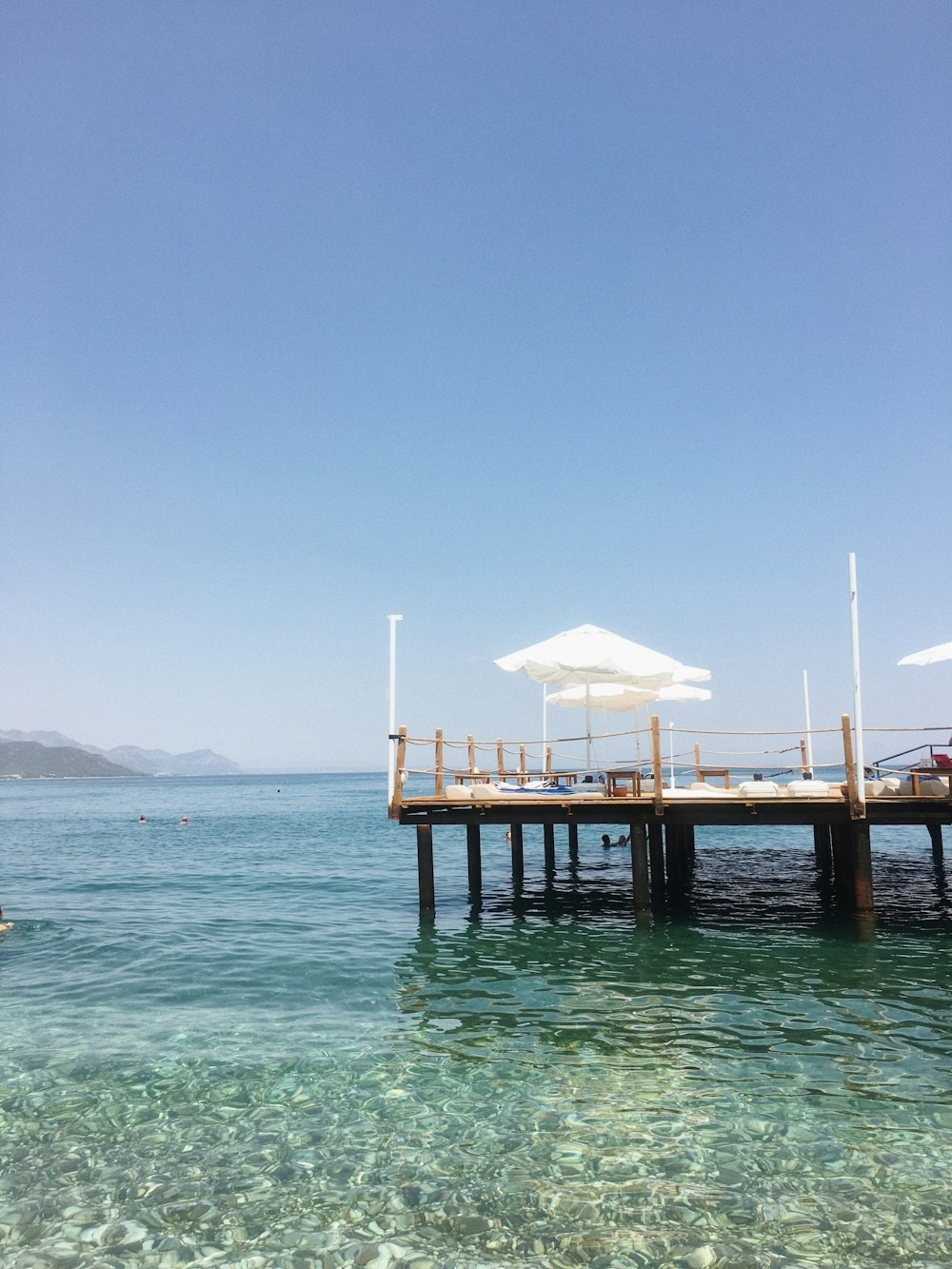 brown wooden dock on sea during daytime