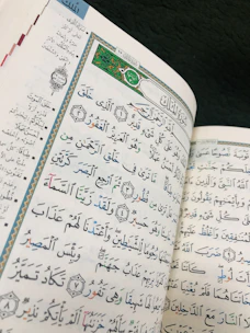 A close-up of a rare Moorish American folklore book with ornate calligraphy on the pages.