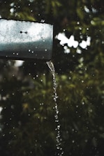 A close-up of clean gutters with clear water flowing through them after a professional service.