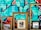 Three ornate picture frames are positioned against a vibrant graffitied wall. Within the frames, there is a painting depicting an outdoor scene, a black and white photograph of a person, and a reflective mirror. The graffiti features abstract shapes and bold colors.