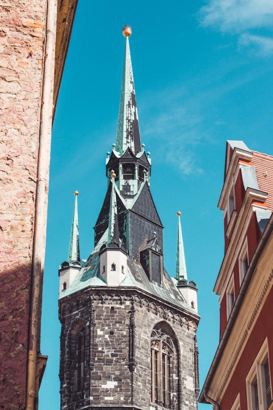 brown brick building under blue sky during daytime in Halle Germany