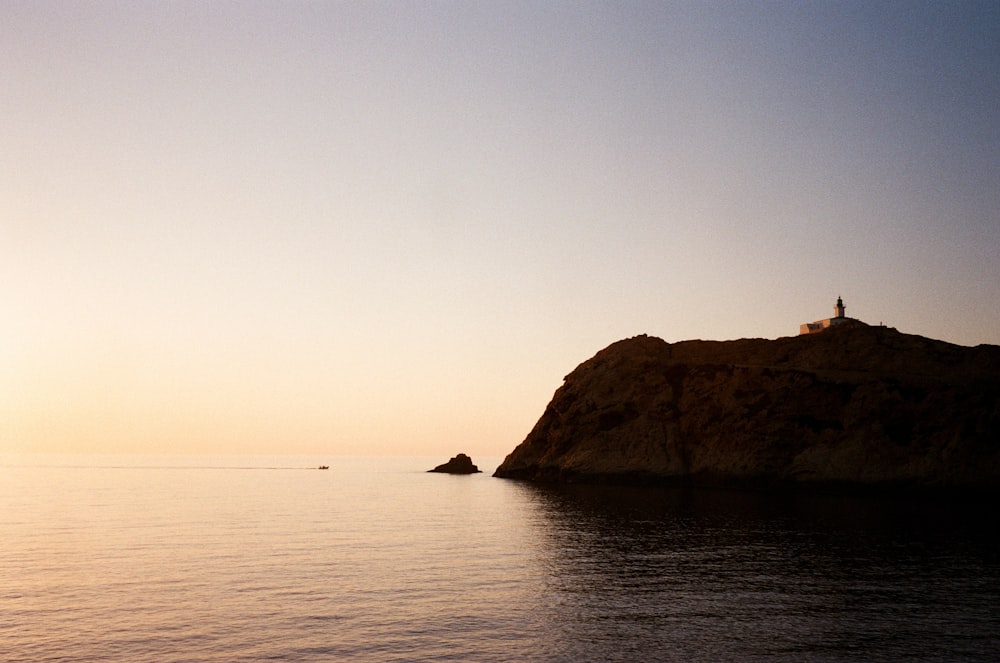 brown rock formation on sea during daytime