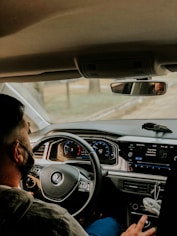 man driving car during daytime