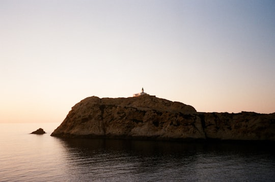 silhouette of person standing on rock formation in front of sea during daytime in Corse France