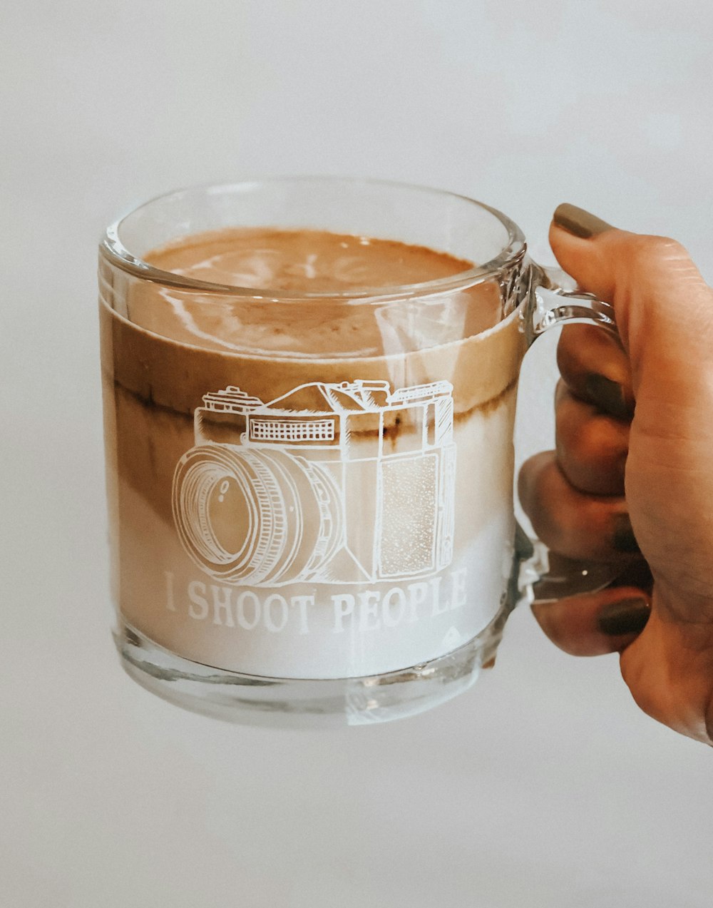 clear glass mug with brown liquid