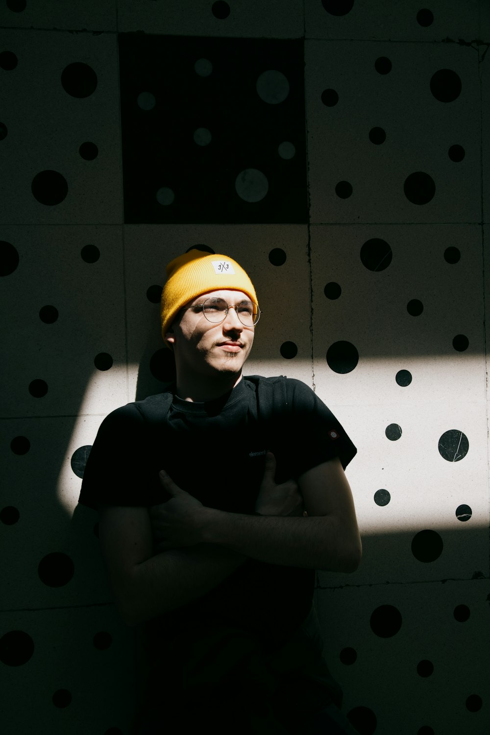 man in black crew neck t-shirt and yellow cap