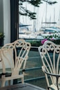 Balcony seating area with comfortable chairs and a view of Labuan Bajo’s marina.