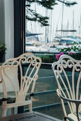 Balcony seating area with comfortable chairs and a view of Labuan Bajo’s marina.
