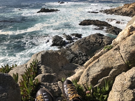 A rugged pair of waterproof boots on a rocky terrain.