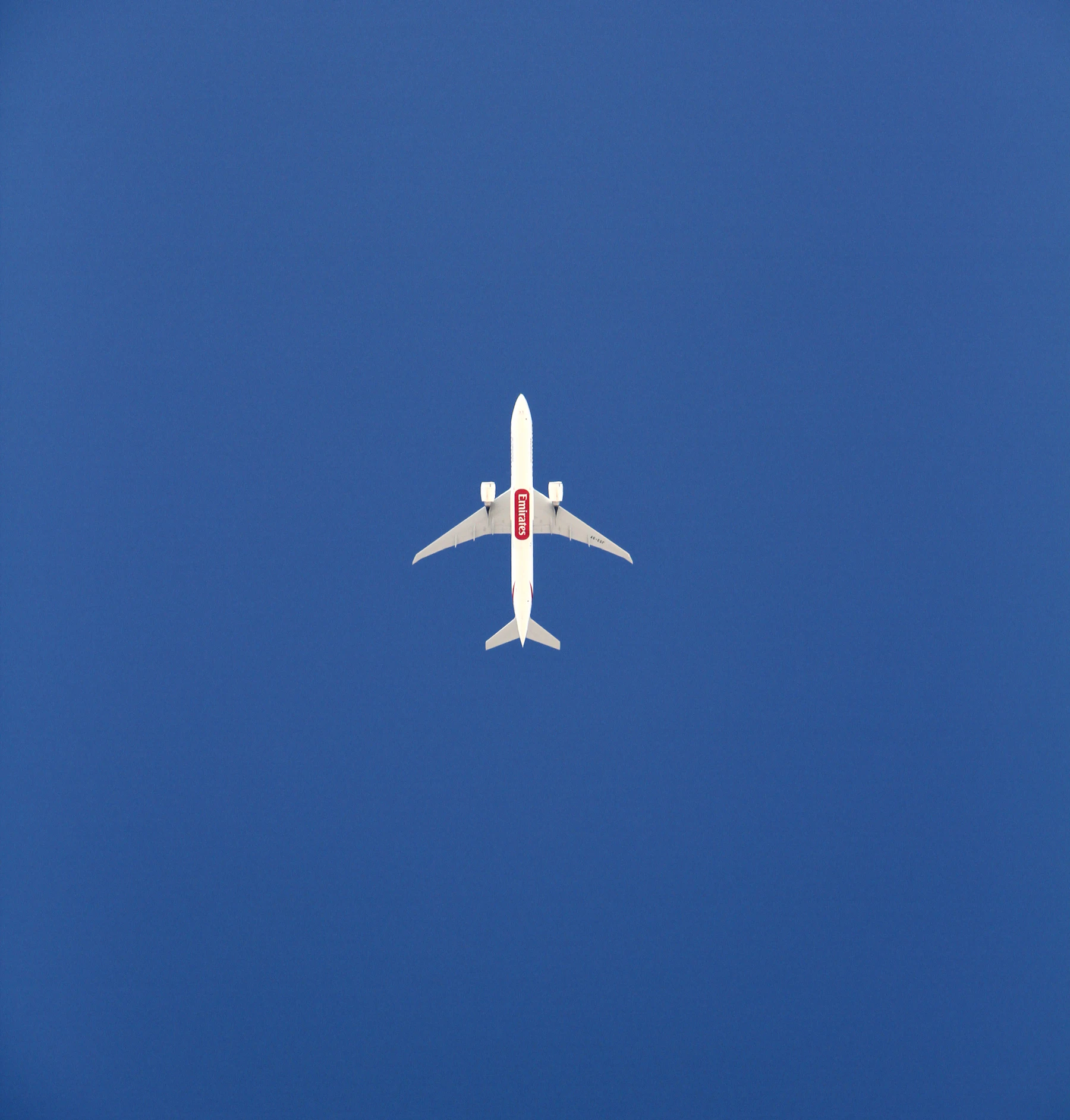 An aeroplane flying in a clear blue sky