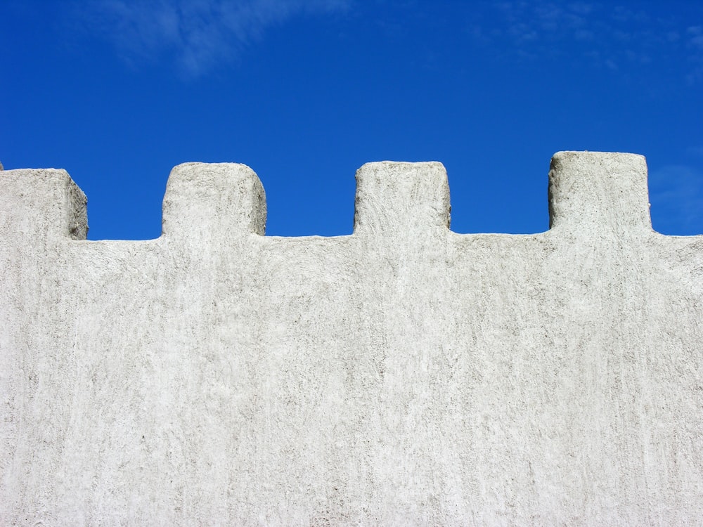 muro di cemento bianco sotto il cielo blu durante il giorno