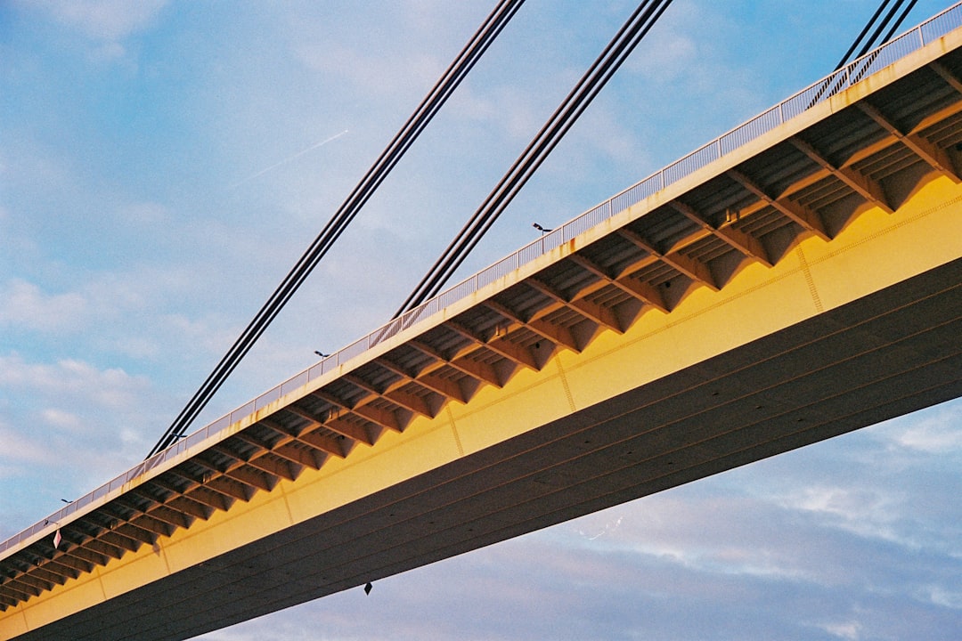 brown and white bridge under blue sky