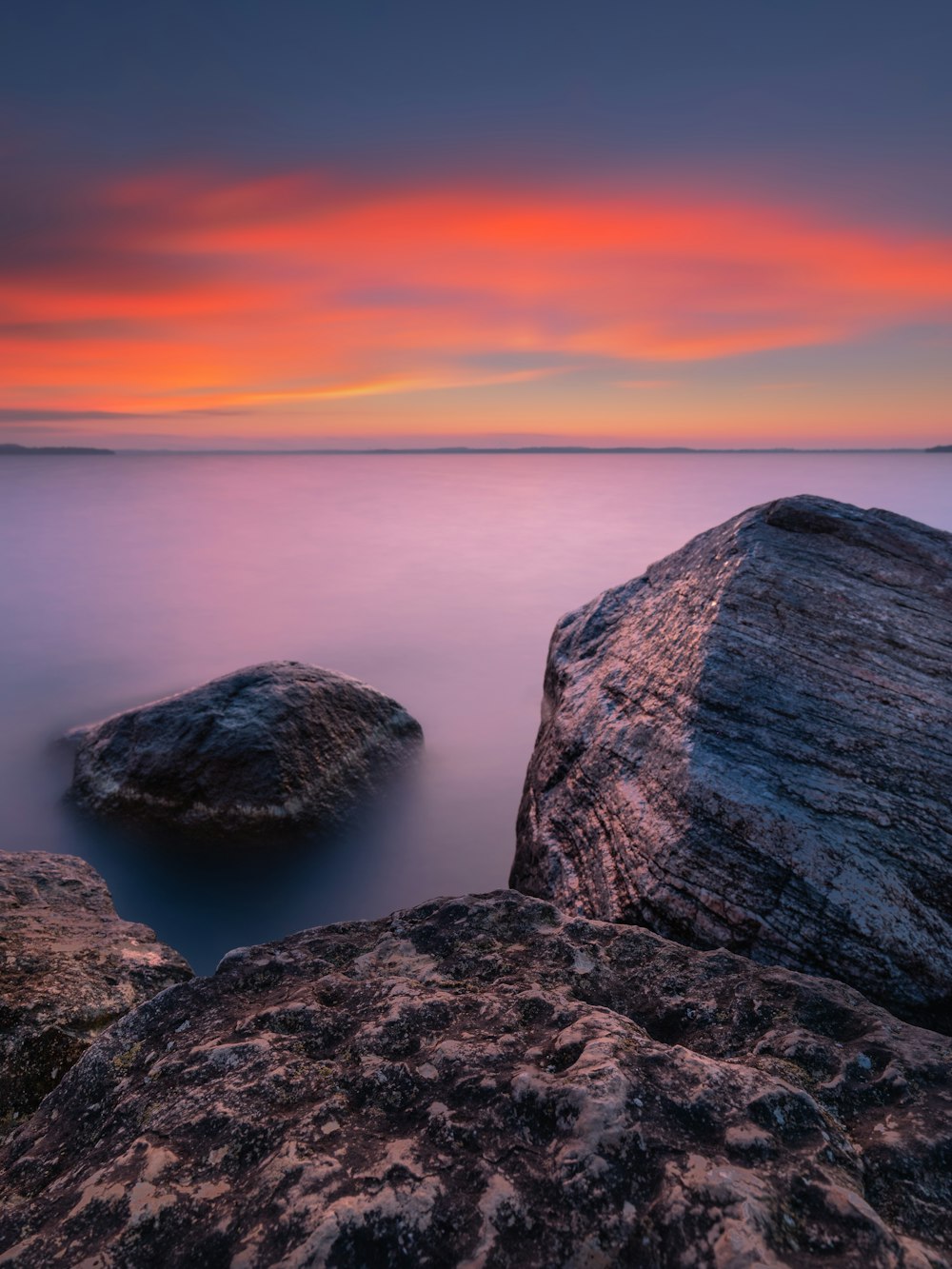 brown rock formation near body of water during daytime